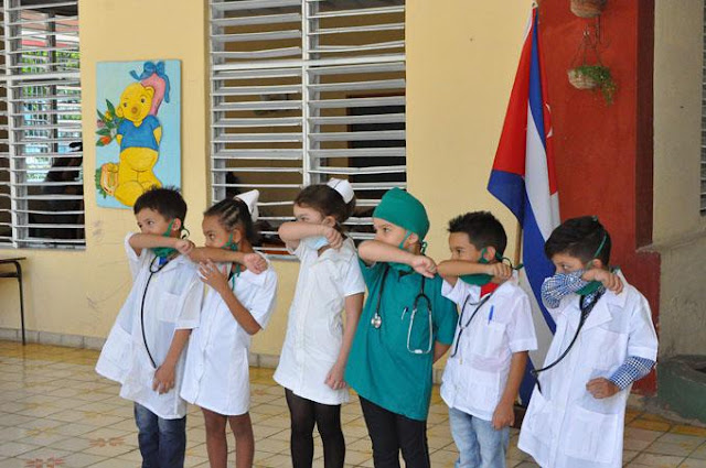 LITTLE DOCTORS AND NURSES OF CUBA , TEACHING THEIR FELLOW PUBLIC ABOUT PUBLIC HEALTH MEASURES