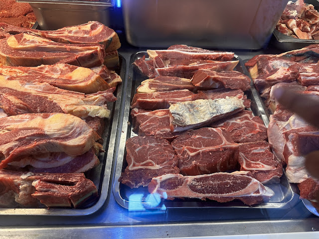 A HINDUSTANI BUTCHER SELLS HALAL MEAT TO BRASILIANS LIVING IN PARAMARIBO SURINAME